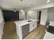 Open concept kitchen with island and living area view at 825 Chalmers St, Durham, NC 27707
