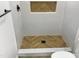 Modern shower with herringbone patterned wood-look tile floor at 825 Chalmers St, Durham, NC 27707