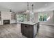 Open concept kitchen with island, stainless steel appliances, and hardwood floors at 112 Lambert Ln, Fuquay Varina, NC 27526