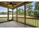 Relaxing screened porch with wooden flooring and ceiling fan at 112 Lambert Ln, Fuquay Varina, NC 27526