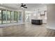Spacious living room with hardwood floors, fireplace, and access to screened porch at 112 Lambert Ln, Fuquay Varina, NC 27526