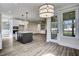 Open kitchen features island, stainless steel appliances, and access to screened porch at 112 Lambert Ln, Fuquay Varina, NC 27526
