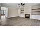 Living room features hardwood floors, fireplace, built-in shelving, and lots of natural light at 112 Lambert Ln, Fuquay Varina, NC 27526