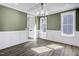 Dining room with green walls, white wainscoting, and hardwood floors at 112 Lambert Ln, Fuquay Varina, NC 27526