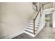 Elegant staircase with a wooden railing and hardwood floors at 112 Lambert Ln, Fuquay Varina, NC 27526