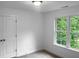 Bright bedroom with large window and carpeted floor at 1611 Carriage Dr, Franklinton, NC 27525