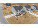 Aerial view of the front of a new two-story house in a residential area at 535 Husketh Rd, Youngsville, NC 27596