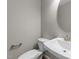 Half bathroom with white sink, toilet, and oval mirror at 535 Husketh Rd, Youngsville, NC 27596