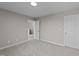 Empty, carpeted bedroom with a door open to the hallway at 535 Husketh Rd, Youngsville, NC 27596