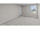 Empty bedroom with neutral gray carpet and large window at 535 Husketh Rd, Youngsville, NC 27596