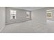 Spacious bedroom with gray carpet and multiple windows at 535 Husketh Rd, Youngsville, NC 27596