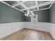 Dining room with coffered ceiling, wainscoting, and modern chandelier at 535 Husketh Rd, Youngsville, NC 27596