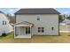 Back exterior of a two-story house with covered patio and lawn at 535 Husketh Rd, Youngsville, NC 27596