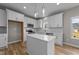 Bright, spacious kitchen with white cabinetry, quartz counters, and a center island at 535 Husketh Rd, Youngsville, NC 27596