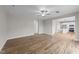 Living room with wood-look floors, neutral walls and view into the kitchen at 535 Husketh Rd, Youngsville, NC 27596