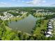 Aerial view of a lakefront community with numerous houses and lush green landscape at 3721 Brightwood Ln, Durham, NC 27703