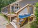 Wooden deck with a blue planter and stairs at 2620 Alston Chapel Rd, Pittsboro, NC 27312