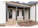 Inviting front porch with brick steps and dark columns at 1690 Terry Rd, Durham, NC 27712