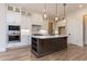 Modern kitchen with white cabinets, island, and stainless steel appliances at 1690 Terry Rd, Durham, NC 27712