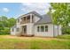 Rear view of a two-story home showcasing a large deck and balcony at 242 Lakestone Estates, Pittsboro, NC 27312