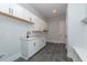 Convenient laundry room with white cabinets and a utility sink at 242 Lakestone Estates, Pittsboro, NC 27312