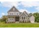 Two story home with gray siding, stone accents, and a welcoming front porch at 242 Lakestone Estates, Pittsboro, NC 27312