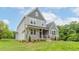Two-story house featuring gray siding, stone accents, and a welcoming front porch at 242 Lakestone Estates, Pittsboro, NC 27312