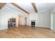 Living area with hardwood floors, exposed beams, and a fireplace at 242 Lakestone Estates, Pittsboro, NC 27312