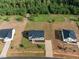 Three homes on adjacent lots, showcasing new construction at 125 Brookhaven Dr, Spring Hope, NC 27882