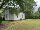 Gray house with red brick foundation and large yard at 529 Dexter St, Rocky Mount, NC 27803