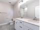 Modern bathroom featuring double vanity, white cabinets, and gray tile flooring at 1713 Grassy Falls Ln, Wendell, NC 27591