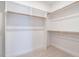 Spacious walk-in closet with built-in shelving and hanging rods at 1713 Grassy Falls Ln, Wendell, NC 27591
