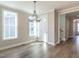 Spacious dining area with wood floors and ample natural light from large windows at 1713 Grassy Falls Ln, Wendell, NC 27591