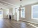 Dining room with a modern chandelier, large windows, and hardwood flooring at 1713 Grassy Falls Ln, Wendell, NC 27591