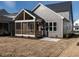 Rear exterior view showcasing screened porch, landscaping, and gray siding at 1713 Grassy Falls Ln, Wendell, NC 27591