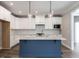 Stylish kitchen featuring white shaker cabinets, a navy blue island, and light countertops at 1713 Grassy Falls Ln, Wendell, NC 27591