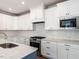 Modern kitchen with white cabinetry, stainless steel appliances, and quartz countertops at 1713 Grassy Falls Ln, Wendell, NC 27591