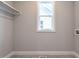 Spacious laundry room with window, hanging rod, and utility connections at 1713 Grassy Falls Ln, Wendell, NC 27591