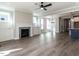 Open living room with fireplace, wood floors, and view to the dining area and kitchen at 1713 Grassy Falls Ln, Wendell, NC 27591