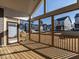 View from the screened porch showcasing the wooden decking, railings, and neighborhood view at 1713 Grassy Falls Ln, Wendell, NC 27591