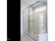 Glass-enclosed shower with tile surround and built-in shelf at 1713 Grassy Falls Ln, Wendell, NC 27591