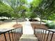 Inviting walkway lined with trees and stone walls leads to the home entrance at 712 Groveview Wynd, Wendell, NC 27591