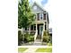 Two-story home with gray and burgundy siding, front porch, and landscaping at 712 Groveview Wynd, Wendell, NC 27591