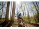 Person mountain biking on wooded trails at 1719 Grassy Falls Ln, Wendell, NC 27591