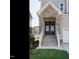 Front entry with brick columns, double doors, and stairs leading to the porch at 1719 Grassy Falls Ln, Wendell, NC 27591