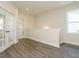 Bright landing area with hardwood floors and access to laundry room at 1719 Grassy Falls Ln, Wendell, NC 27591