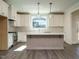 Modern kitchen with white cabinets, quartz countertops and island at 1719 Grassy Falls Ln, Wendell, NC 27591