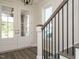 Bright entryway with white double doors, hardwood floors, and elegant staircase at 1719 Grassy Falls Ln, Wendell, NC 27591