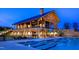 Evening view of community pool and clubhouse at 1719 Grassy Falls Ln, Wendell, NC 27591