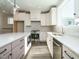 Modern kitchen with white cabinets, quartz countertops and stainless steel appliances at 1719 Grassy Falls Ln, Wendell, NC 27591